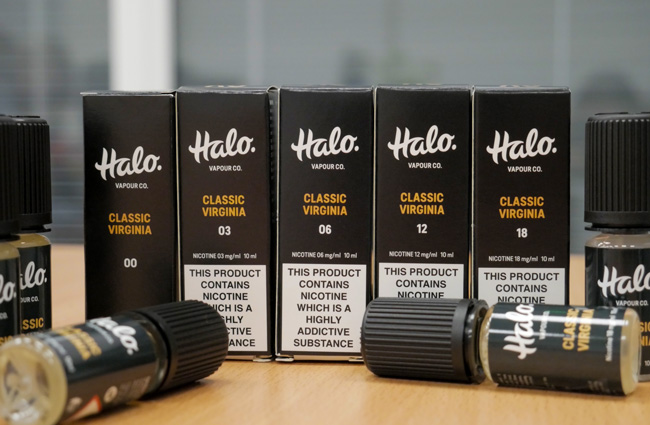 Row of Halo e-liquids, boxed, with unboxed e-liquid bottles in front.
