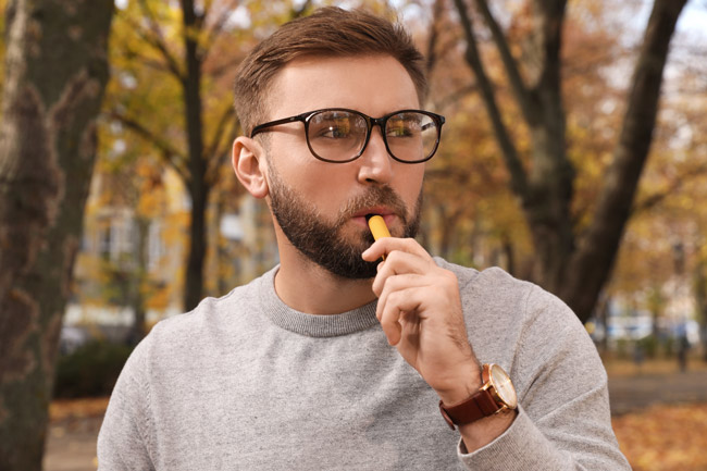 Man vaping a disposable vape.